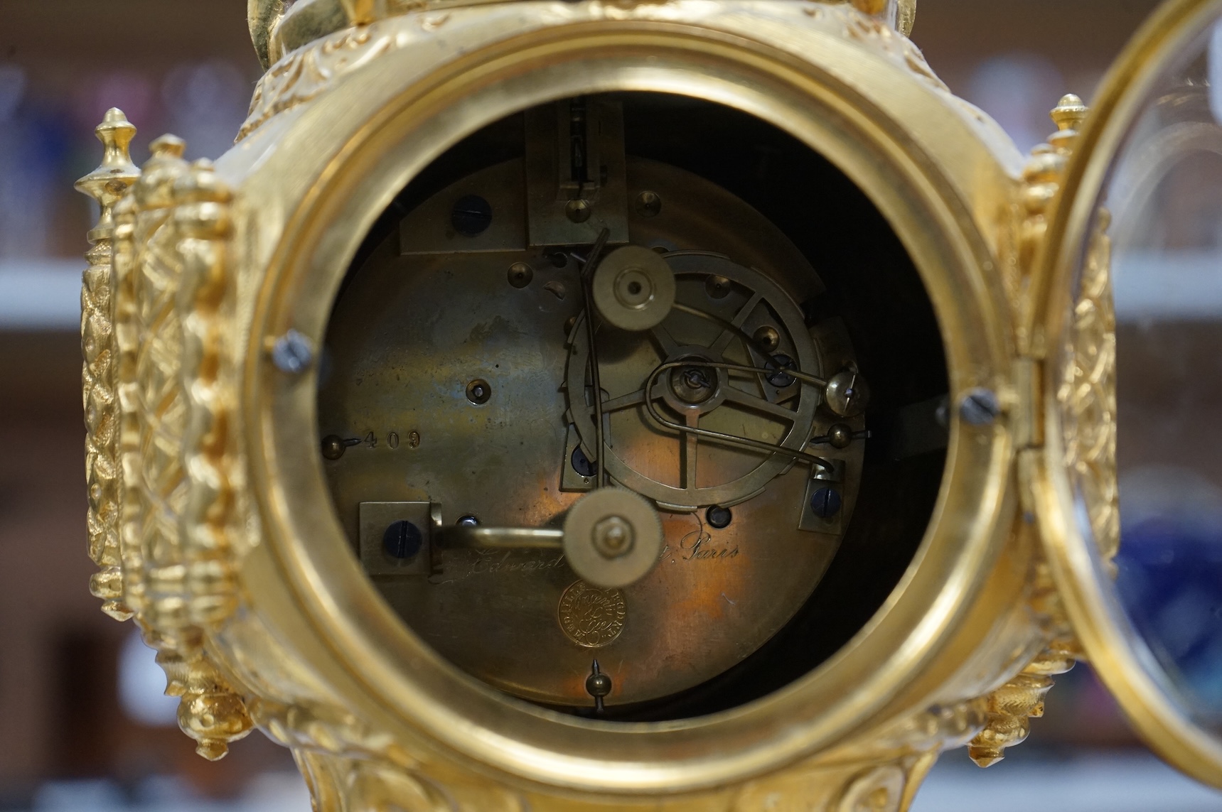 A late 19th century French ormolu mounted clock with enamelled dial and roundels depicting heraldic scenes, the dial inscribed Edward Bright, Paris, with pendulum, no key, 34cm high